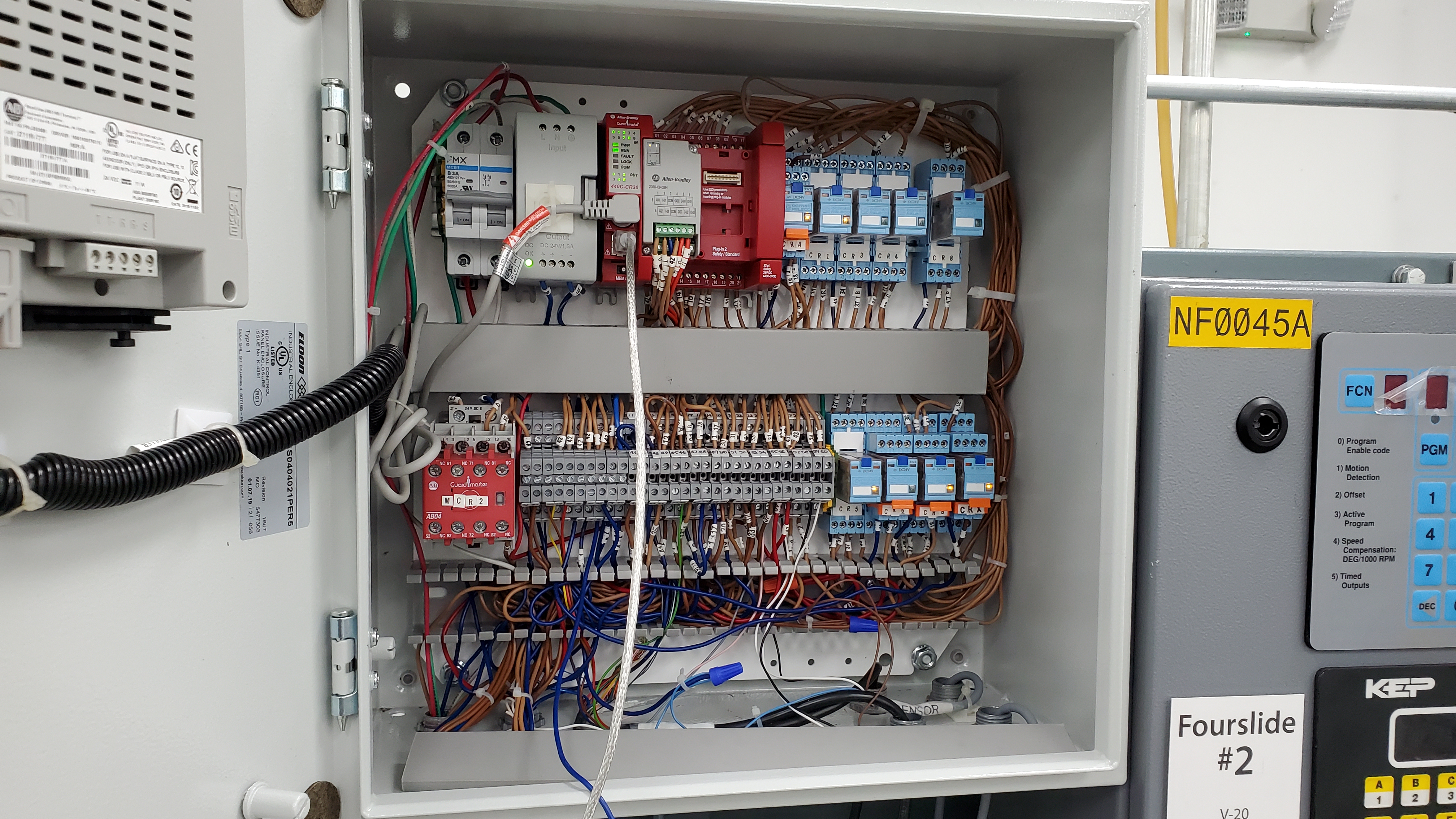 Safety control enclosure showing relay logic integration and machine wiring